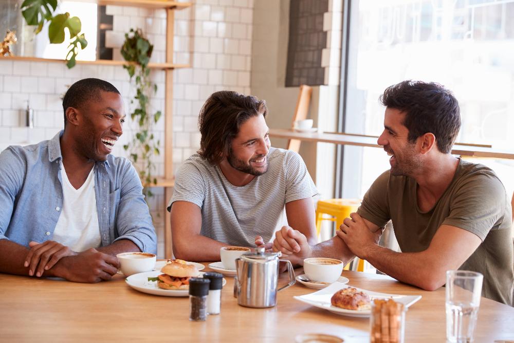 Friends smiling around a table, charlotte nc