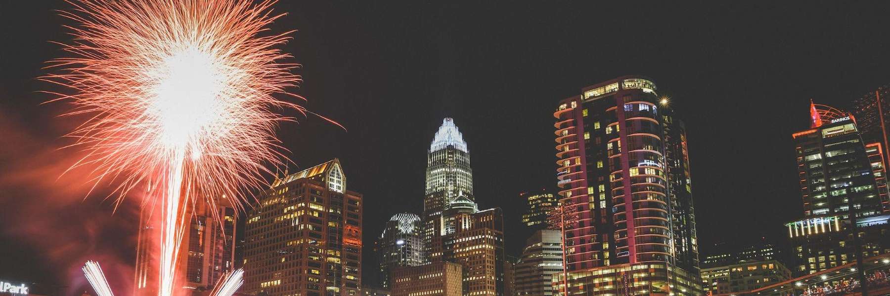 Fireworks going off in front of building skyline, charlotte nc