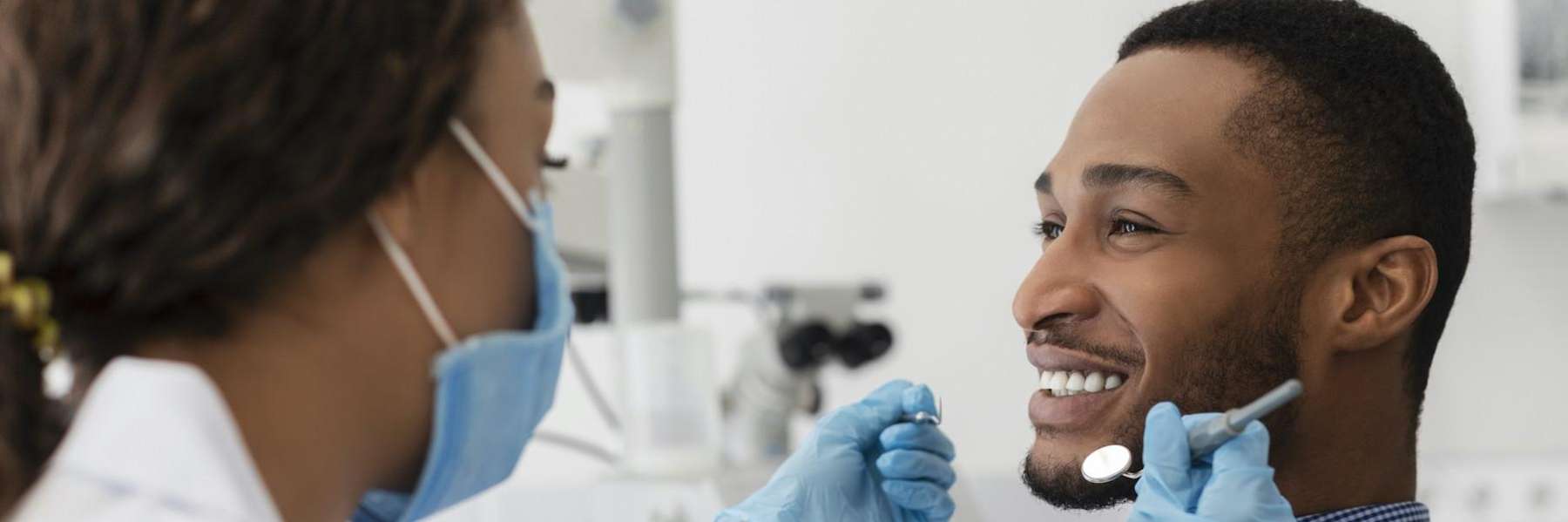 Black man smiling getting teeth checked, charlotte nc