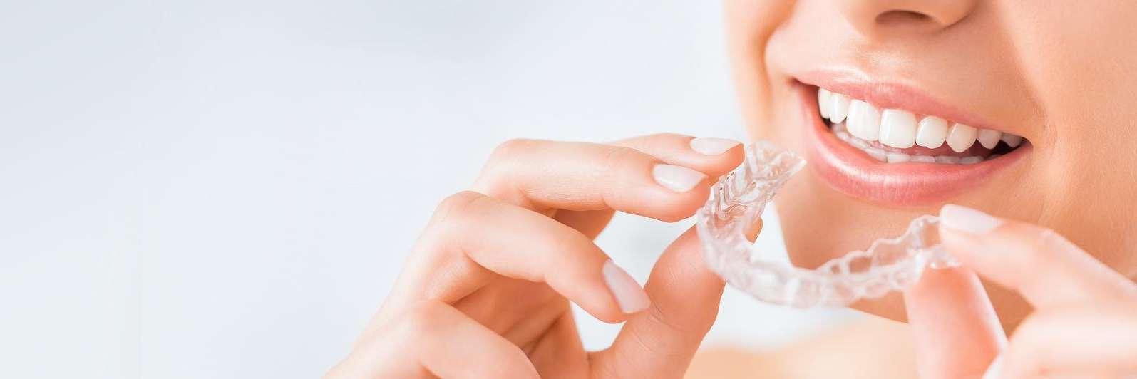 girl putting on invisalign in charlotte nc