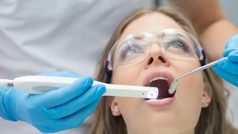 woman receiving dentist exam | root canal therapy steele creek