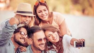 Group of friends taking a selfie after cosmetic dentistry, charlotte nc