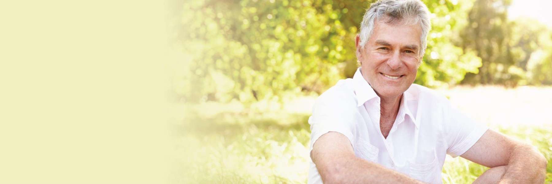 older man sitting on grass | dentist charlotte nc